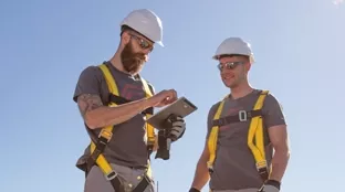 Two installers using tablet for inverter configuration